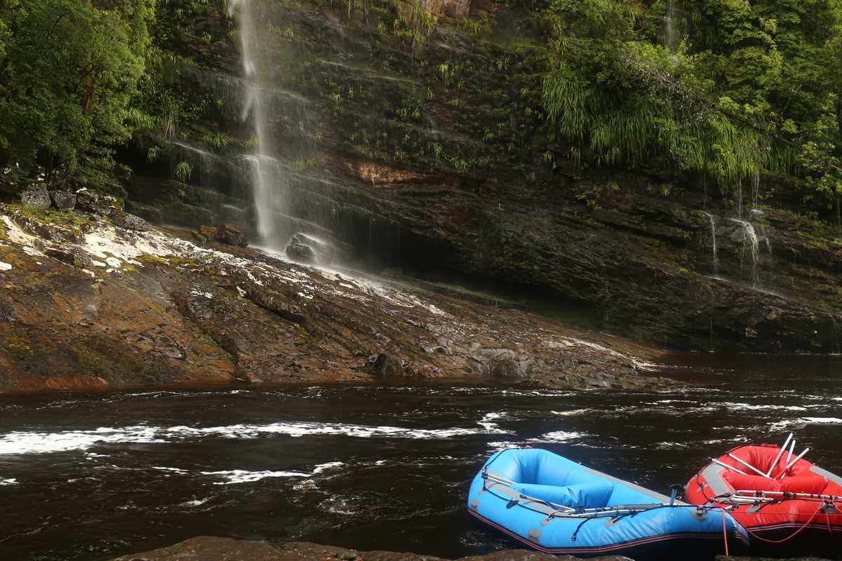 Rafts parked at Shower Cliff Cavern waterfall