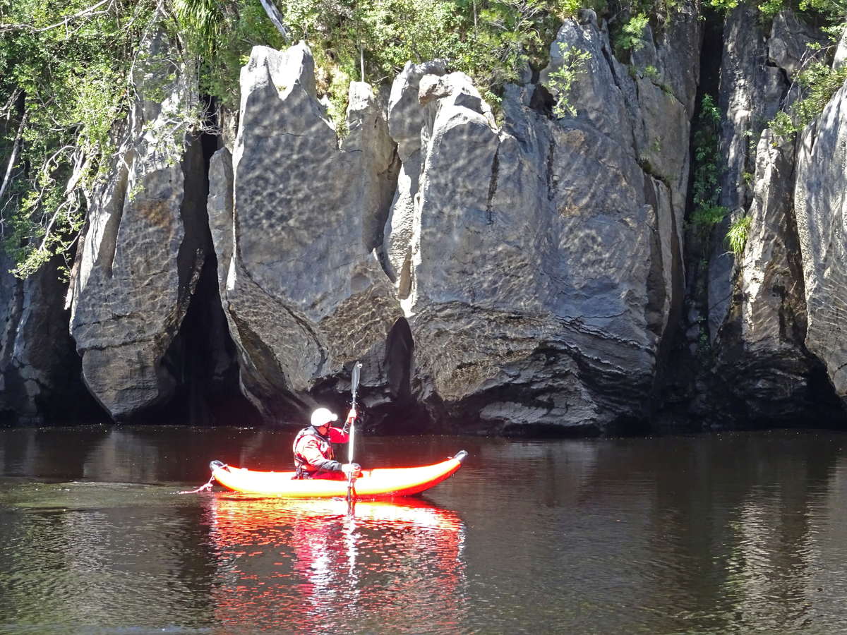 Paddling a duckie past the magnificent Limestone formations along the Lower Franklin River