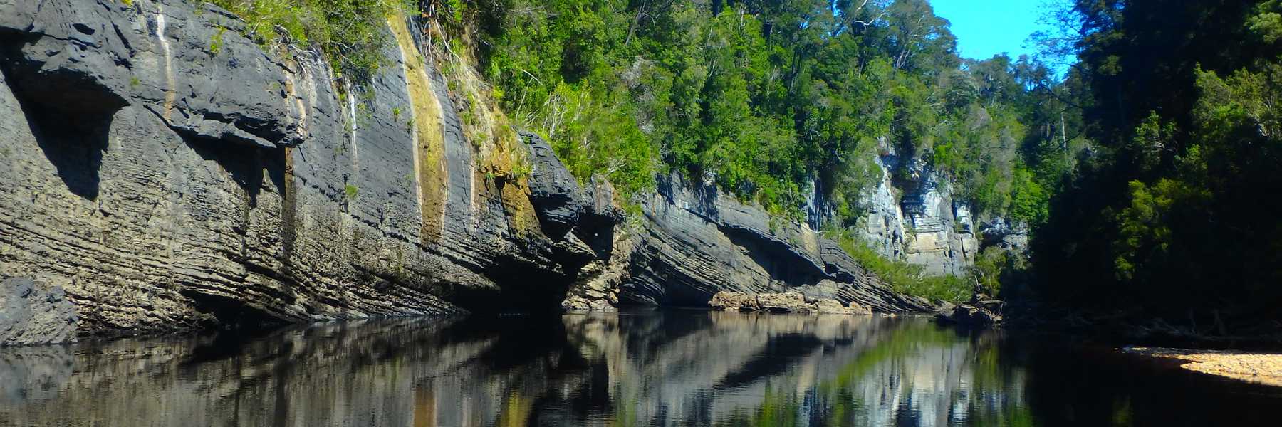 Reflections of limestone cliffs along the Lower Franklin River, Tasmania